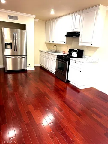 a kitchen with stainless steel appliances granite countertop a stove and a refrigerator