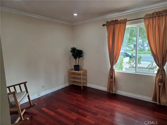 a view of room with window and wooden floor