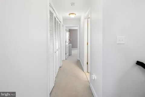 a view of a hallway with white walls