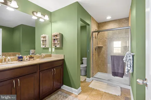 a bathroom with a sink mirror and a shower