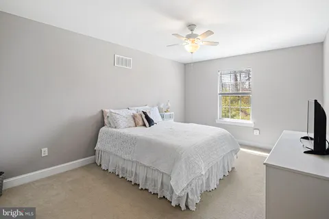 a bedroom with bed and a chandelier