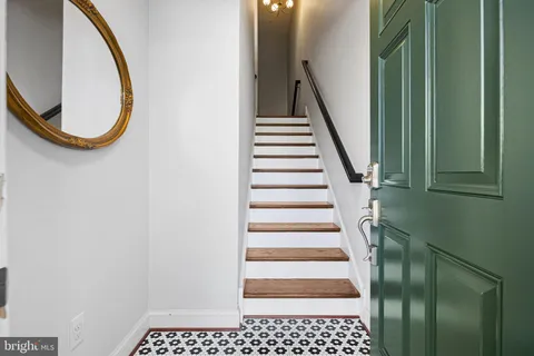 a view of a livingroom with wooden floor and a large window