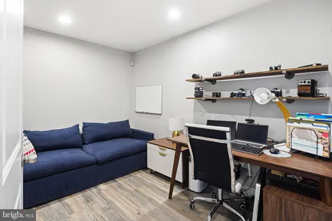 a livingroom with workspace and a couch