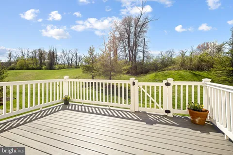 a view of balcony with wooden floor and fence