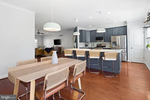 a view of kitchen with cabinets table and chairs
