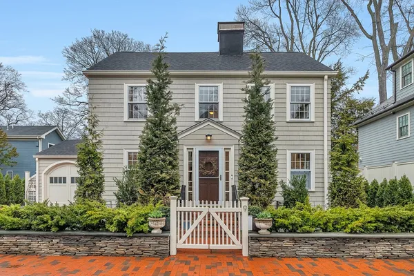 a view of a hallway with wooden floor and a bathroom