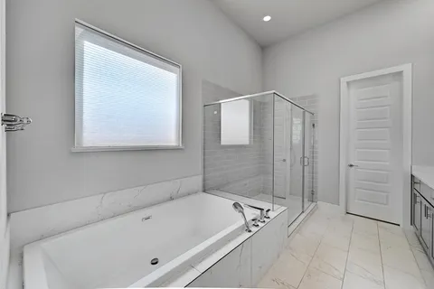 a bathroom with a tub and a shower