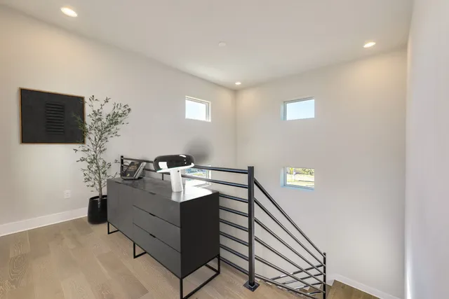 a bedroom with a bed with furniture and a potted plant