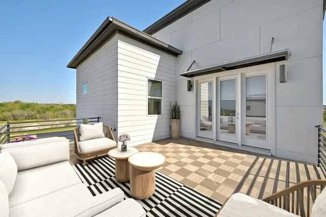 a balcony with furniture and view of a backyard