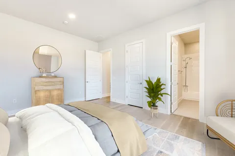 a bedroom with bed and a potted plant