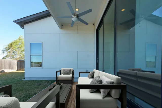 a balcony with a table and chairs