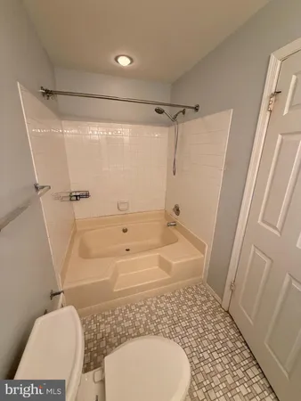 a bathroom with a granite countertop toilet sink and shower