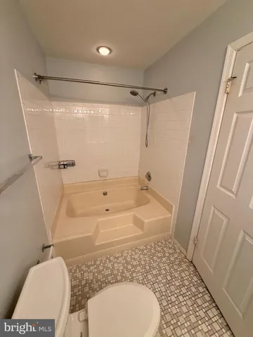 a bathroom with a granite countertop toilet sink and shower