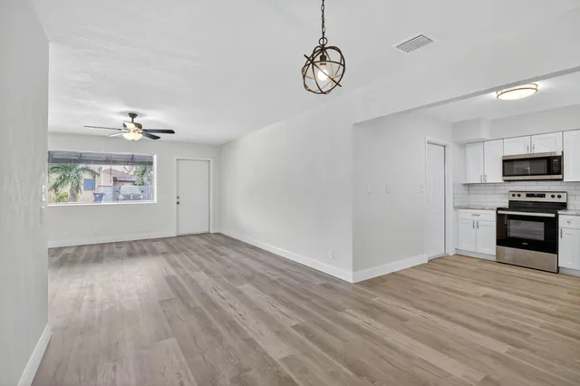a view of a kitchen with microwave and cabinets