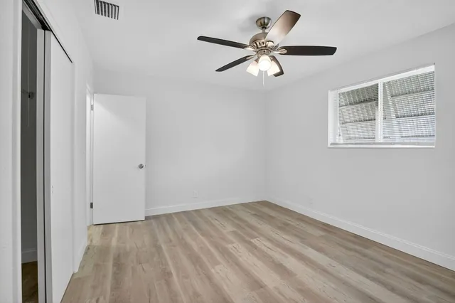 a view of a room with wooden floor and natural light