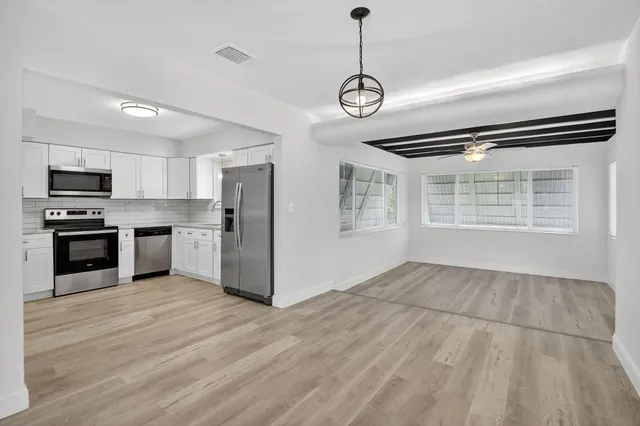 a view of kitchen with sink microwave and refrigerator