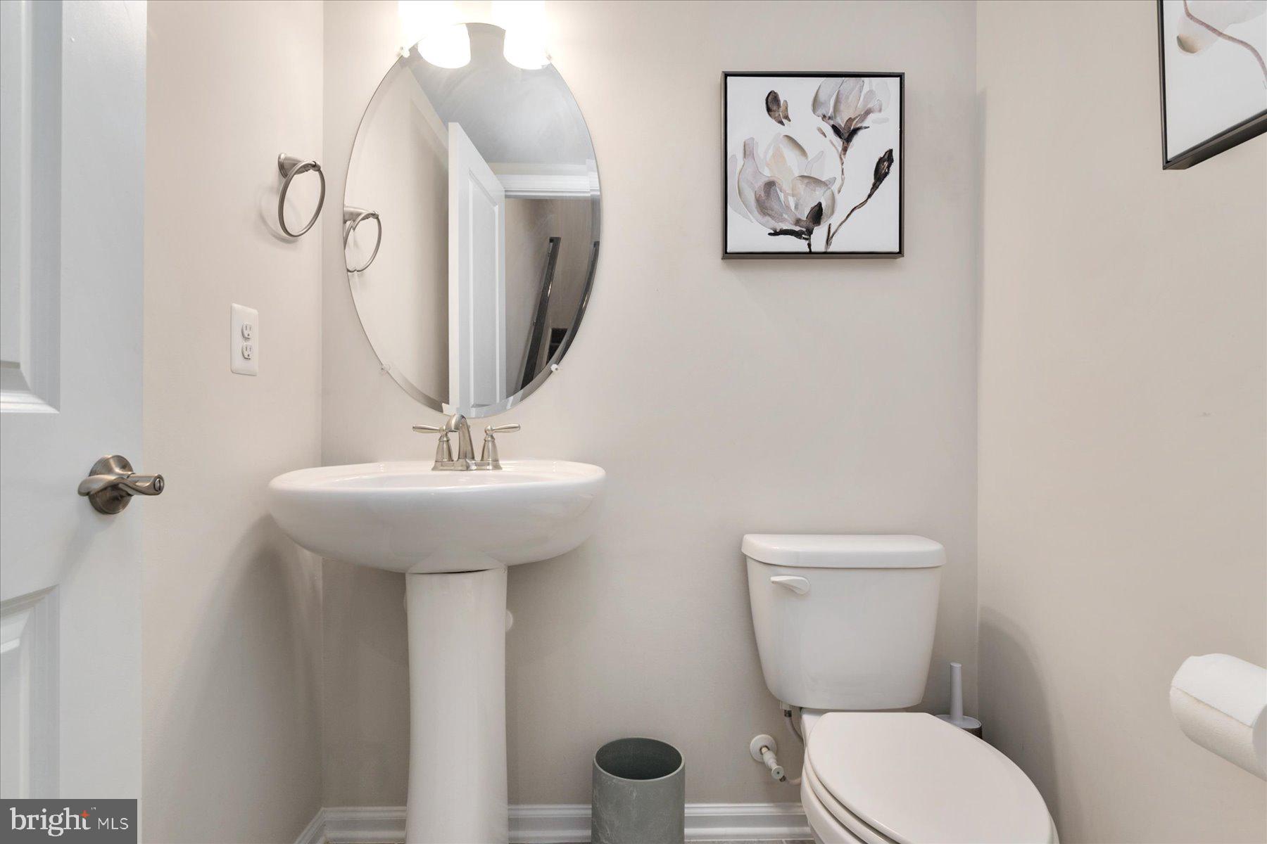 3351 Pitch Pine Drive Laurel, MD 20724 - Photo 25 of 43 a bathroom with a toilet a sink and mirror