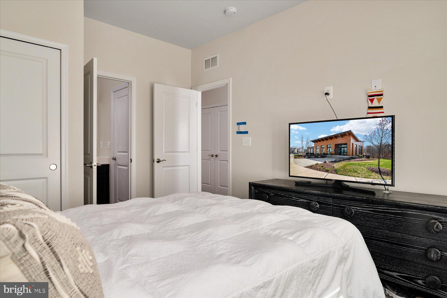 3351 Pitch Pine Drive Laurel, MD 20724 - Photo 27 of 43 a bedroom with a bed and a flat screen tv