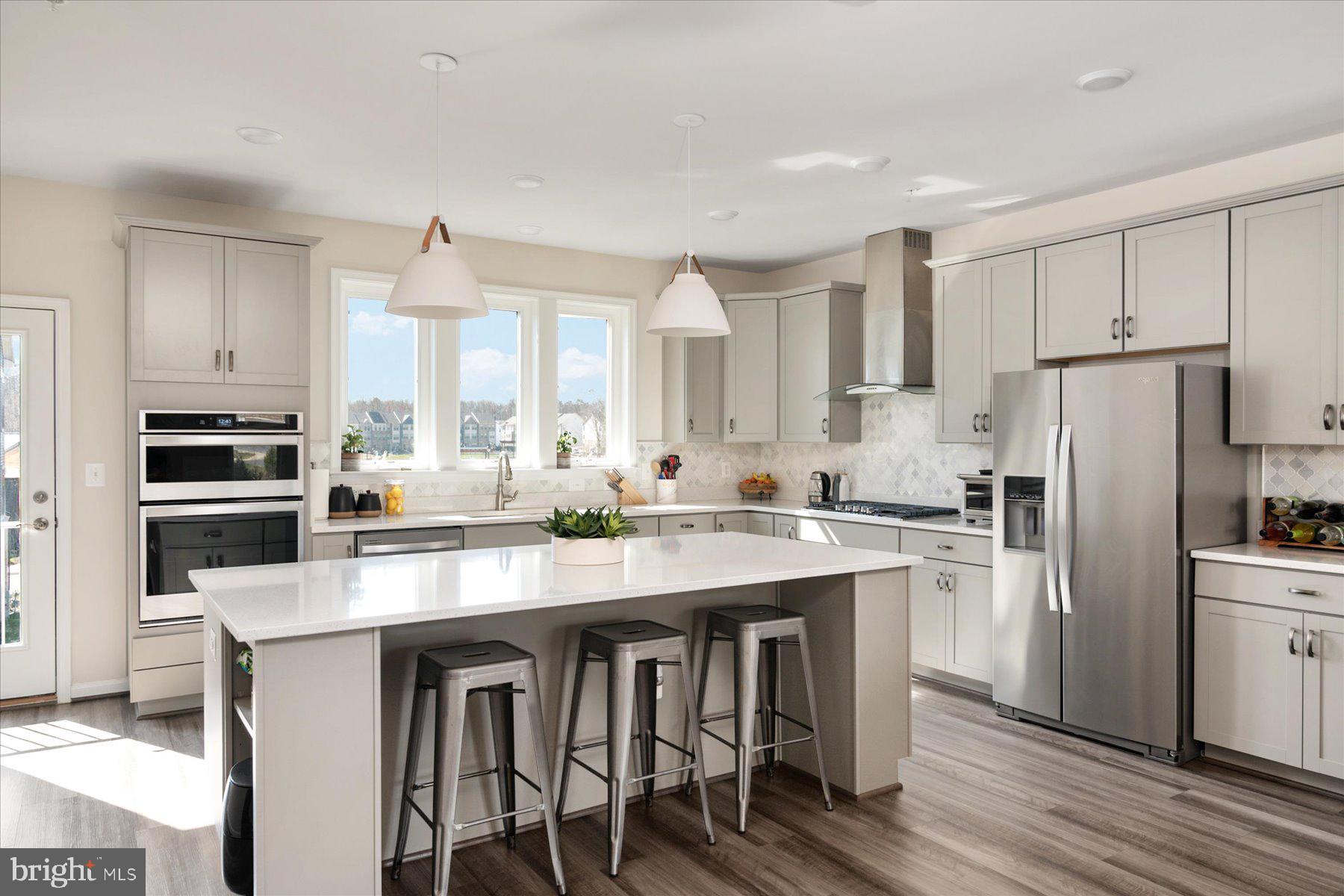 3351 Pitch Pine Drive Laurel, MD 20724 - Photo 3 of 43 a kitchen with stainless steel appliances a sink a stove a refrigerator cabinets and wooden floor