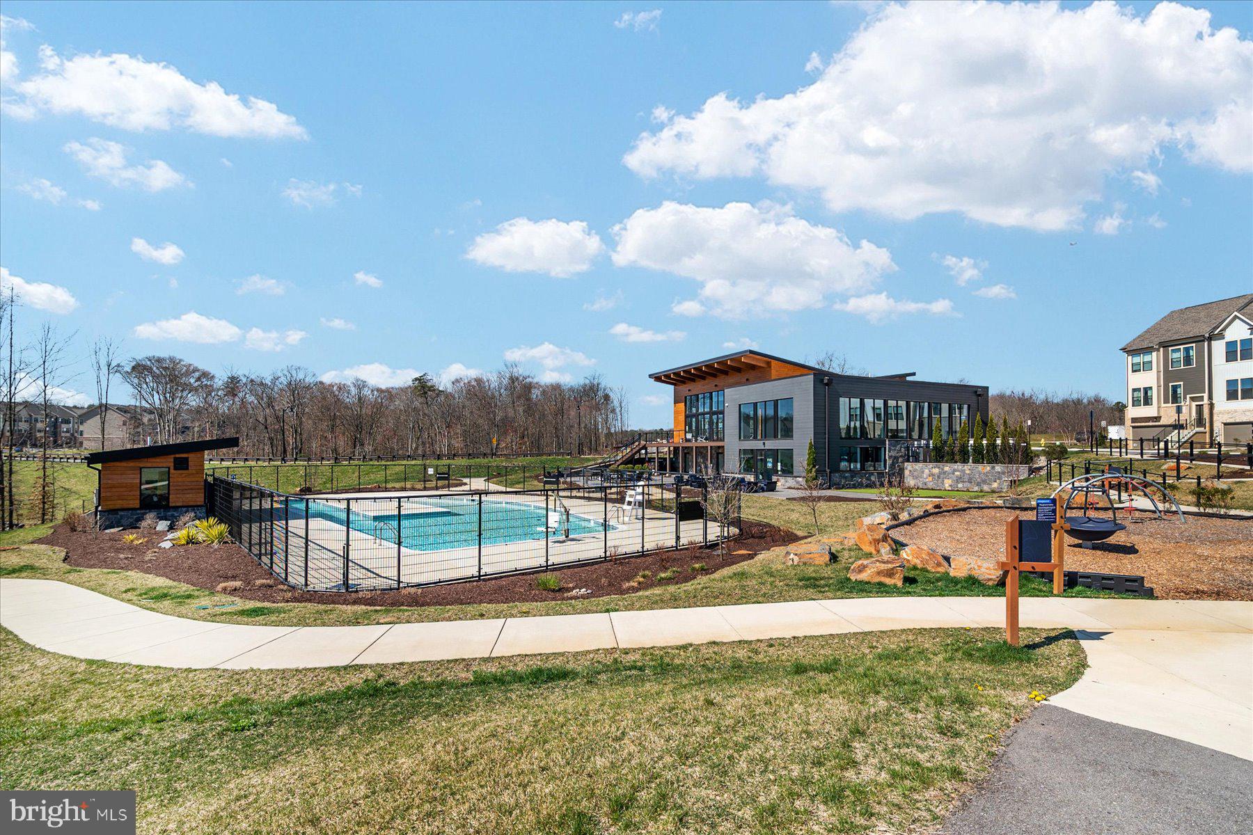 3351 Pitch Pine Drive Laurel, MD 20724 - Photo 40 of 43 a view of a swimming pool with a table and chairs