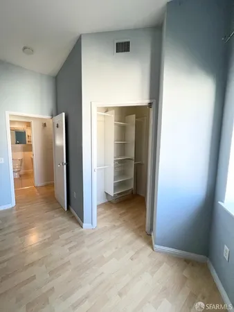an empty room with closet and wooden door