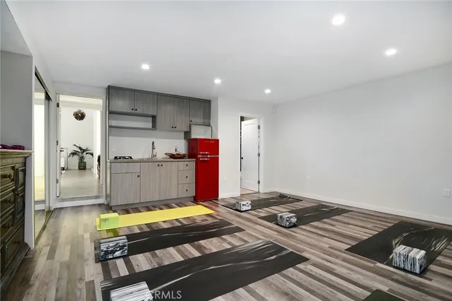 a kitchen with kitchen island granite countertop a sink stove and refrigerator