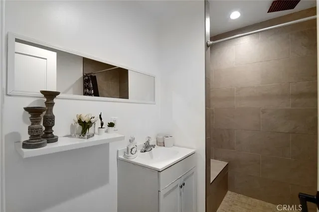 a bathroom with a sink vanity and mirror