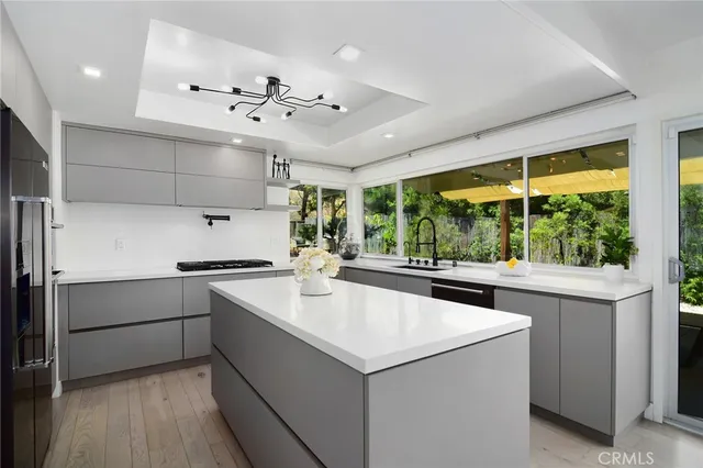 a kitchen with granite countertop a sink stainless steel appliances and cabinets