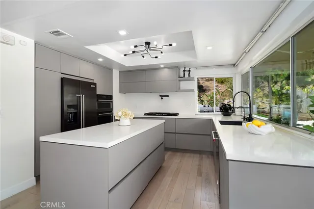 a large white kitchen with a large window