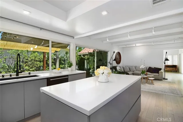 a kitchen with a table chairs and wooden floor