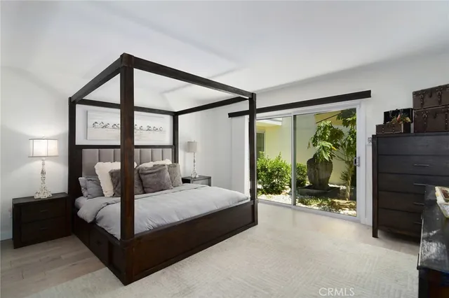 a bedroom with a bed and large window