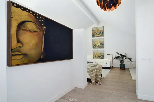a living room with furniture and a painting on the wall