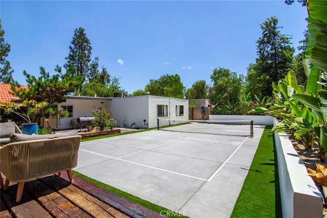 a backyard of a house with table and chairs