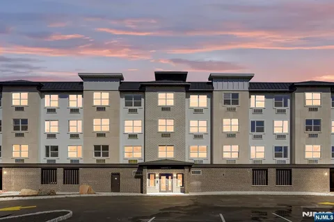 a view of a brick building with many windows