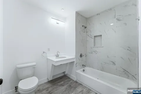 a bathroom with a toilet a sink and bathtub