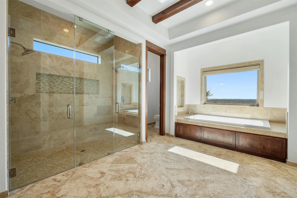 8040 Carlton Ridge Cove Austin, TX 78738 - Photo 17 of 40 a bathroom with a bathtub and a shower