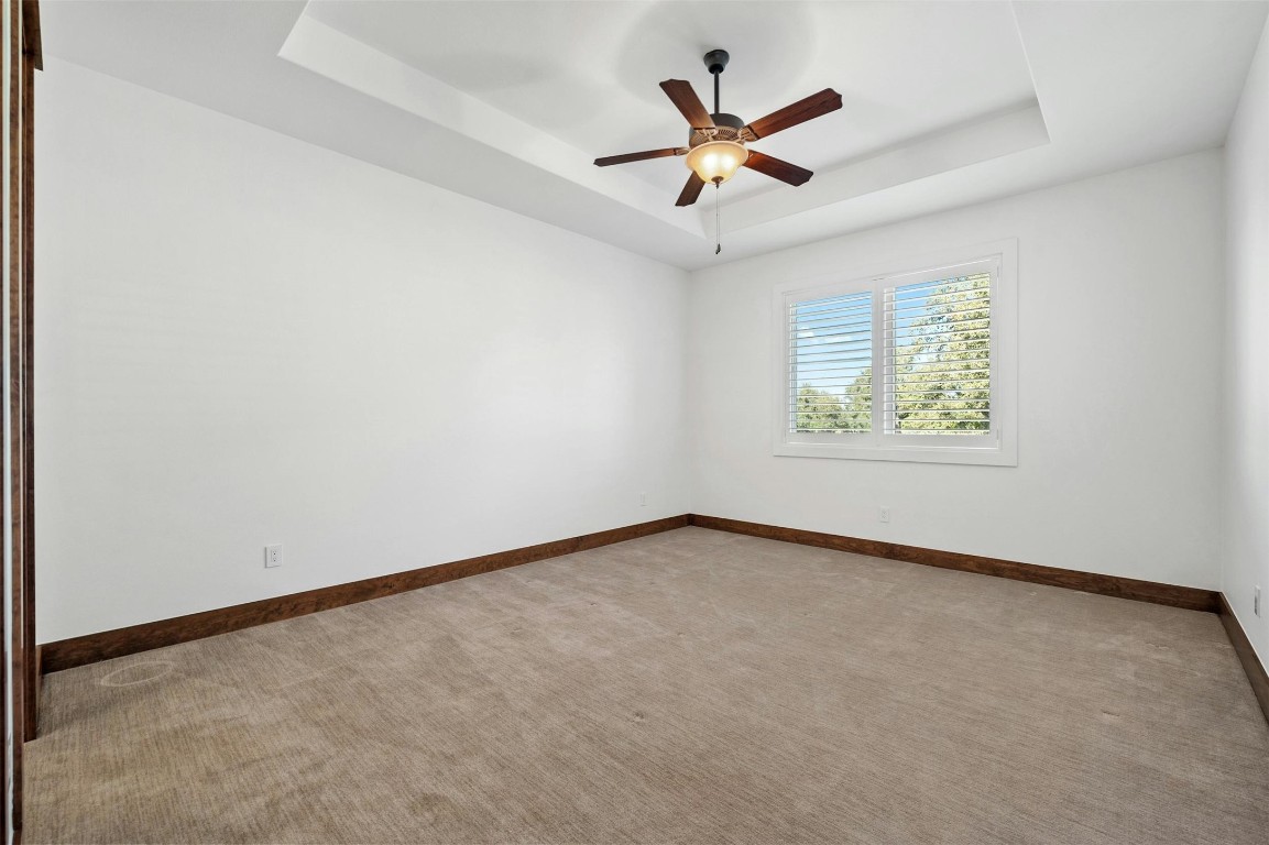8040 Carlton Ridge Cove Austin, TX 78738 - Photo 22 of 40 an empty room with window and ceiling fan