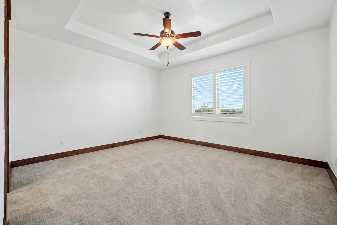 8040 Carlton Ridge Cove Austin, TX 78738 - Photo 24 of 40 an empty room with a window and a ceiling fan
