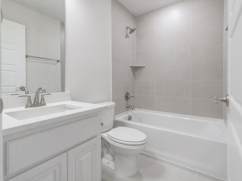 145 Winterwood Drive Lavon, TX 75166 - Photo 24 of 24 Full bathroom featuring tiled shower / bath, vanity, toilet, and tile patterned flooring