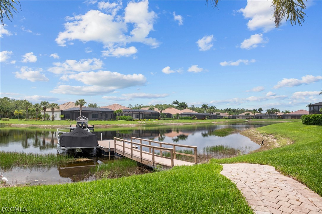 9383 Slate Court Naples, FL 34120 - Photo 5 of 28 a view of a lake with a garden