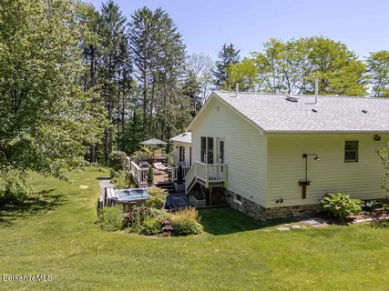 a view of a house with a yard and lake view