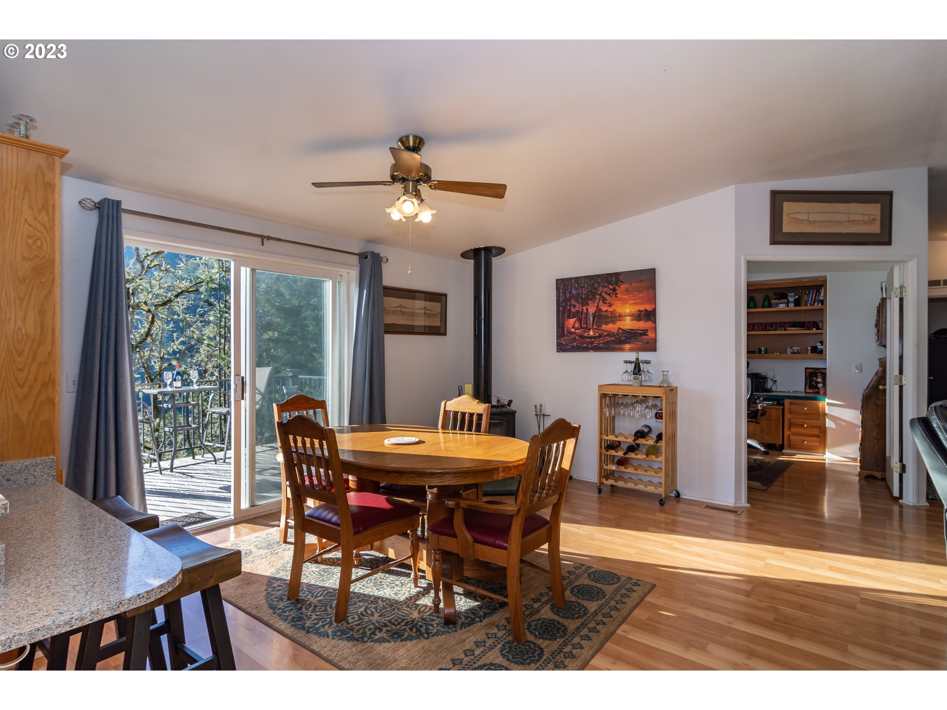 1065 Spring Brook Road Myrtle Creek, OR 97457 - Photo 10 of 48 a dining room with furniture a floor to ceiling window and a flat screen tv