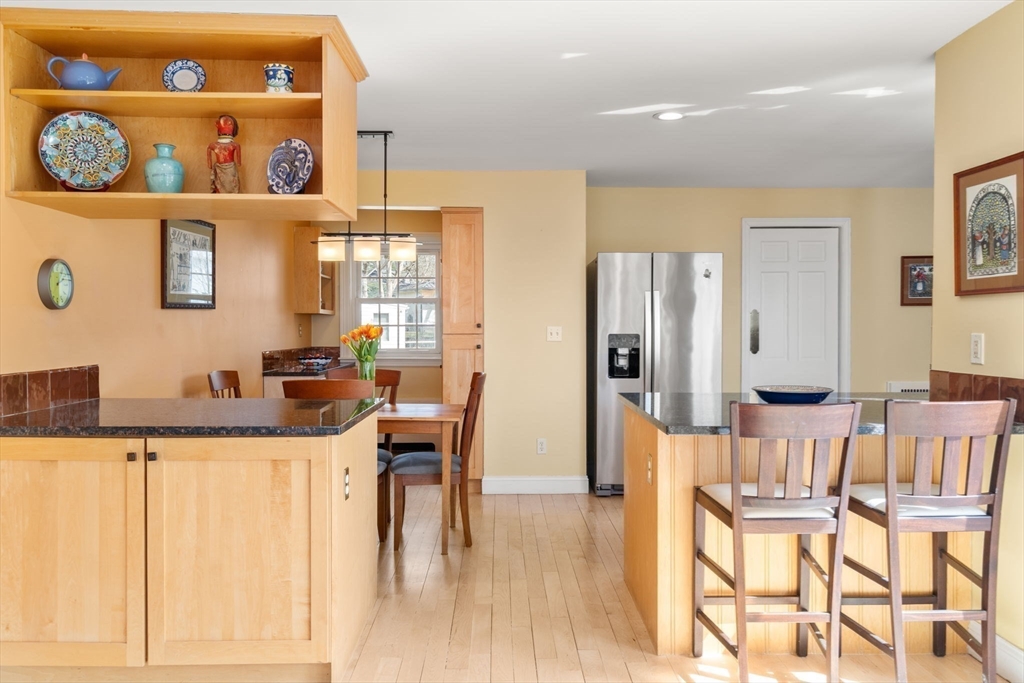 43 Palmer Road Newton, MA 02468 - Photo 24 of 40 a kitchen with stainless steel appliances kitchen island granite countertop a table and chairs