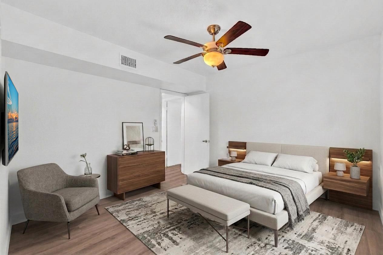 1291 Northwest 13th Street, Unit 445D Boca Raton, FL 33486 - Photo 41 of 50 a bedroom with a bed and a couch