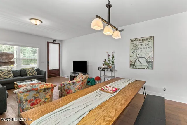 a kitchen with a refrigerator a sink and white cabinets
