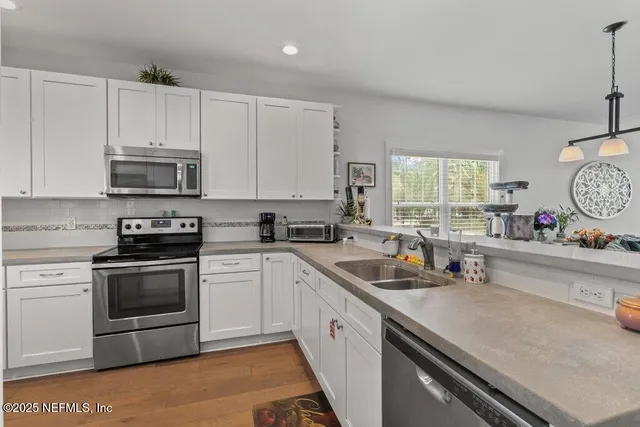 a stove top oven sitting inside of a kitchen