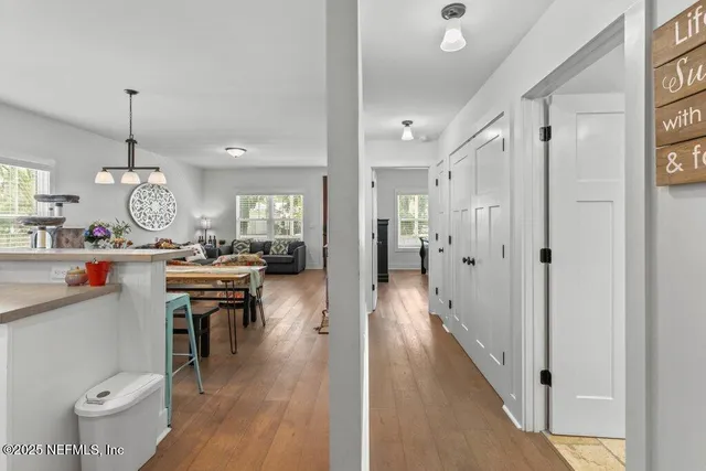 a bathroom with a granite countertop sink a toilet and mirror