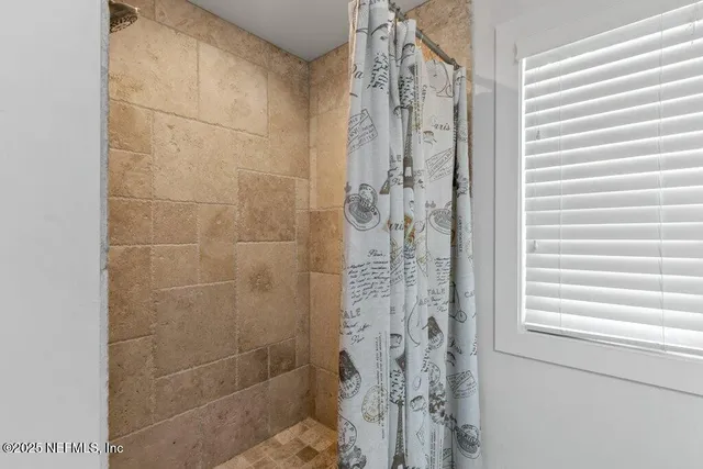 a bedroom with a bed and a night stand