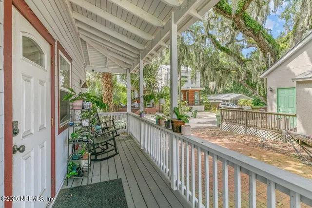 a view of balcony with wooden floor and outdoor seating