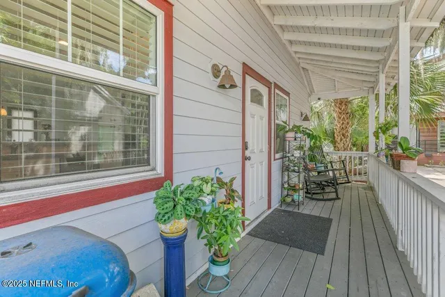 a view of entryway with wooden floor and white walls
